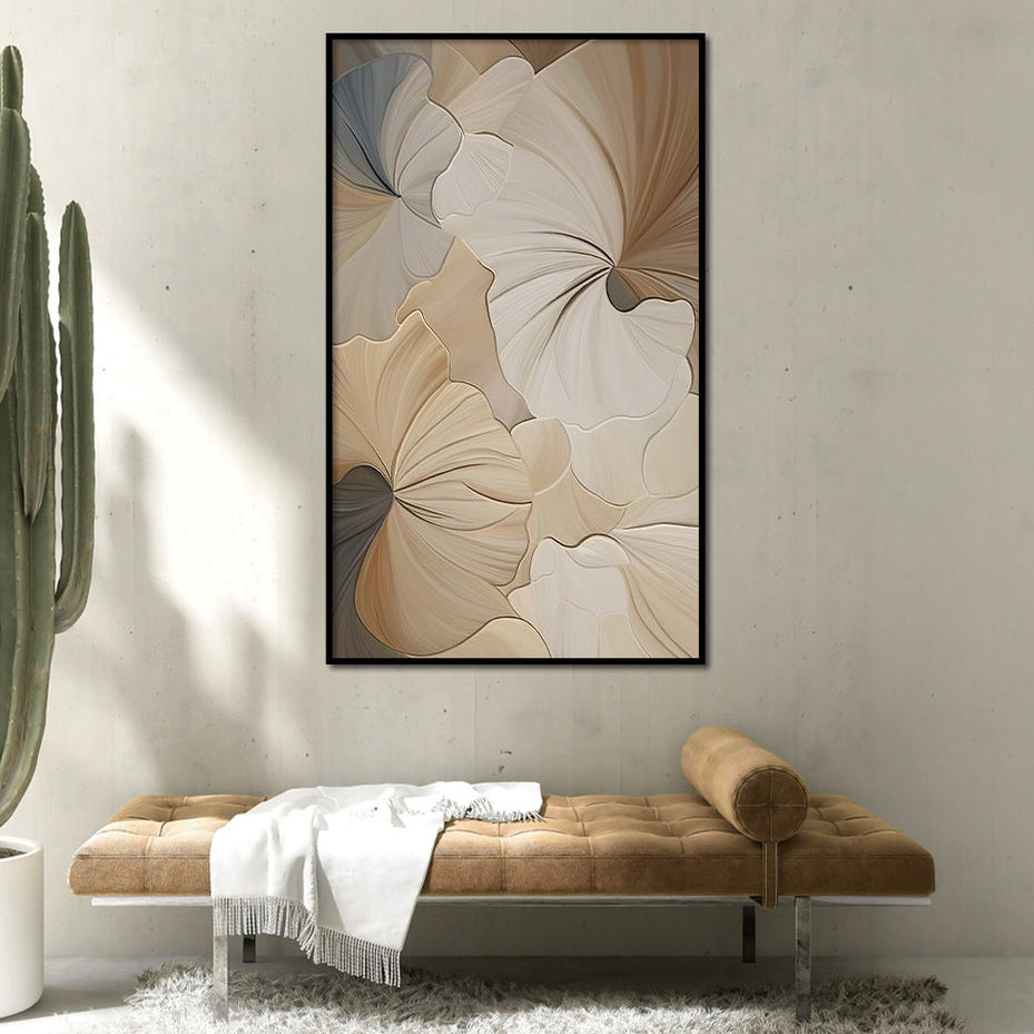 Framed abstract floral art on a wall with a cactus plant and brown bench below.