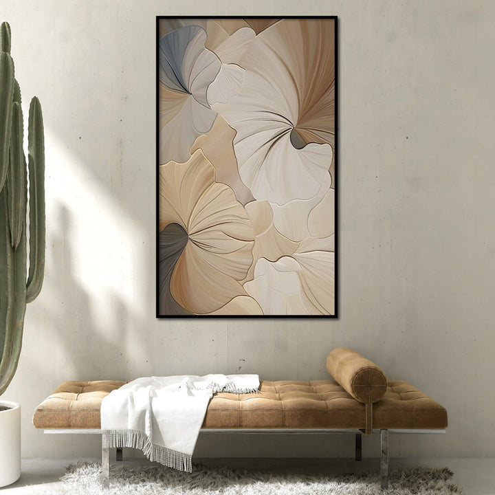 Framed abstract floral art on a wall with a cactus plant and brown bench below.