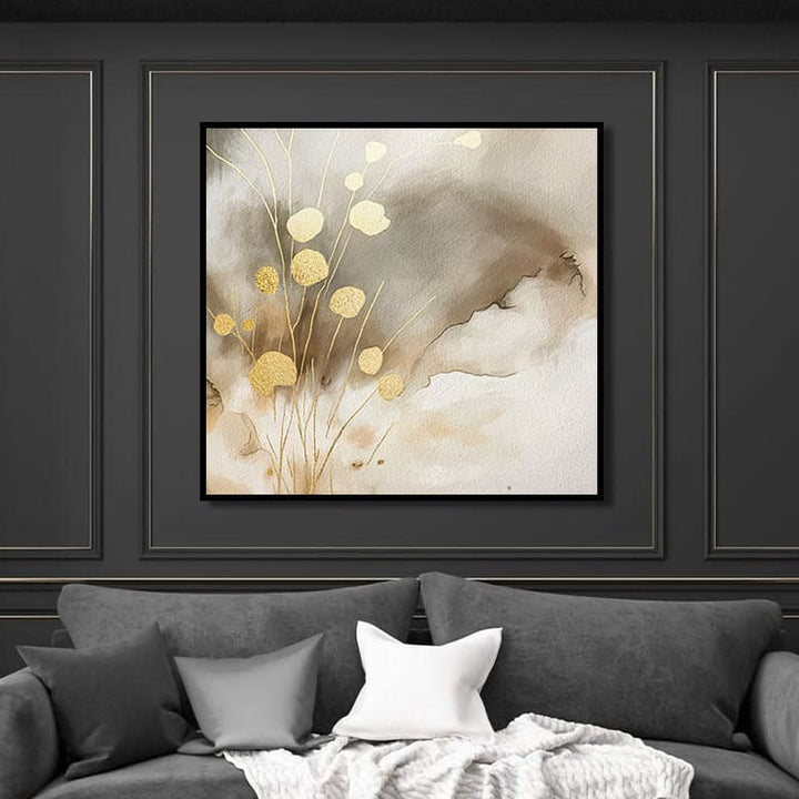Gray sofa with decorative pillows and a blanket in front of a wall with framed abstract painting.