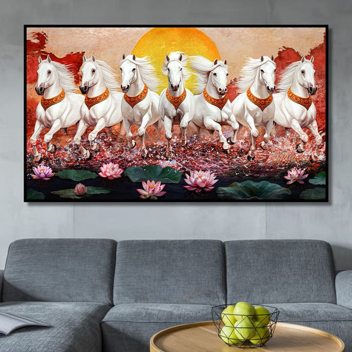 Framed artwork of white horses with orange halos in a natural setting, displayed above a gray sofa.