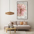 Living room with a pink floral artwork on the wall, gray sofa, and wooden coffee table.