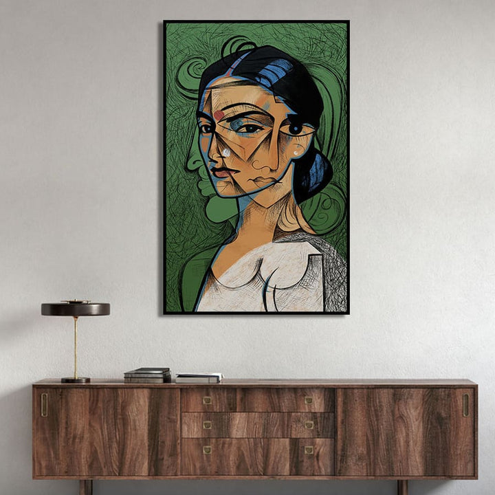 Framed artwork of a stylized portrait on a wall above a wooden cabinet.