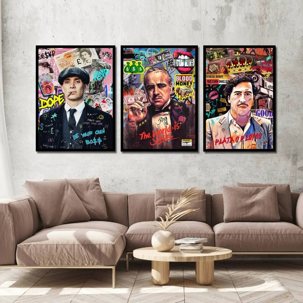 A set of three canvas paintings featuring colorful, graffiti-style illustrations of men with a mafia theme, displayed above a sofa in a living room setting.